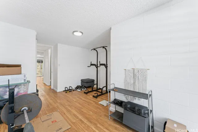 a room with a bed and gym equipment