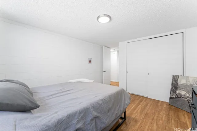 a bedroom with a bed and a mirror