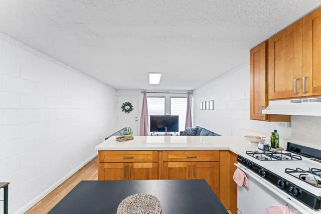a kitchen with stainless steel appliances granite countertop a sink stove and cabinets