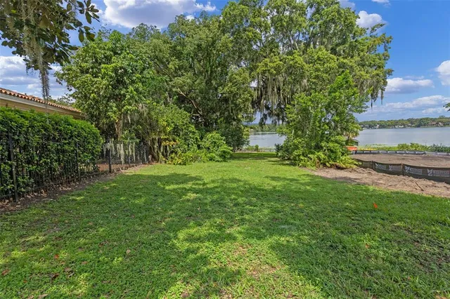 an aerial view of a houses with a yard