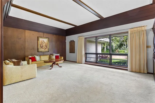 a living room with furniture a rug and a shower