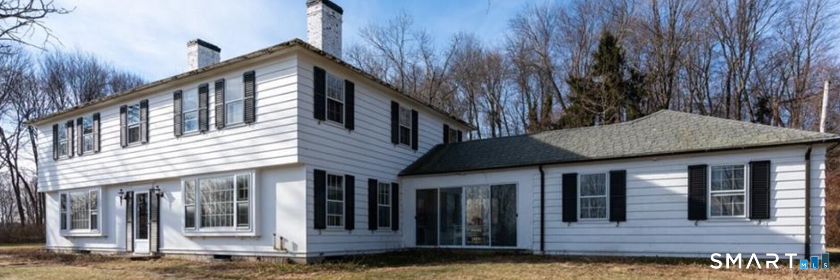 321 Artillery Road Middlebury, CT 06762 - Photo 1 of 15 a view of a house with large windows and a small yard