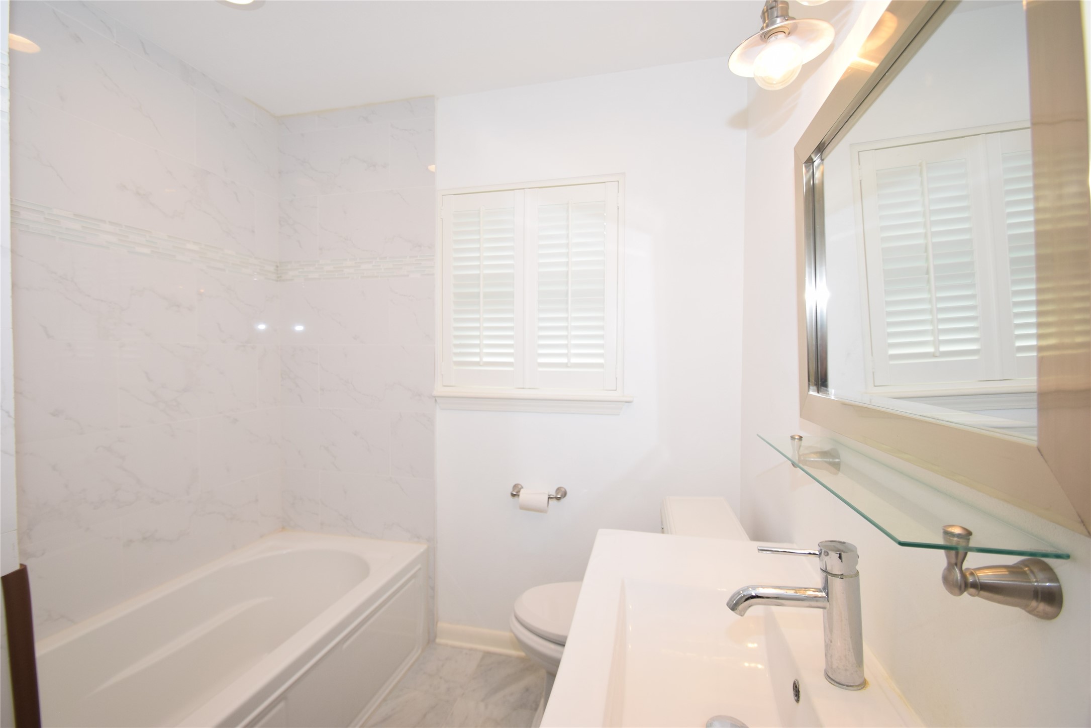 8434 Bluegate Street Houston, TX 77025 - Photo 24 of 28 a bathroom with a sink a toilet and bathtub