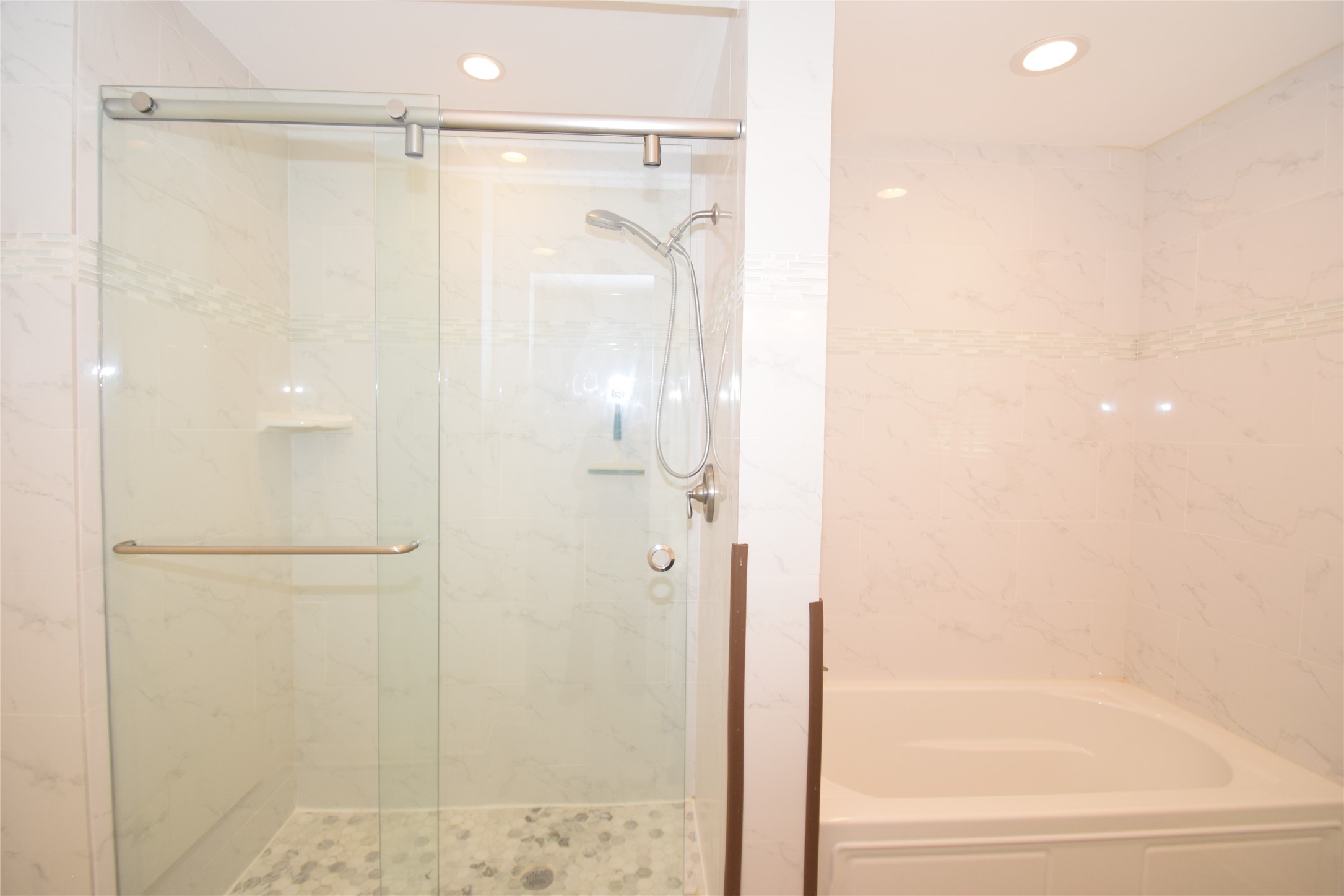 8434 Bluegate Street Houston, TX 77025 - Photo 25 of 28 a bathroom with a glass shower door