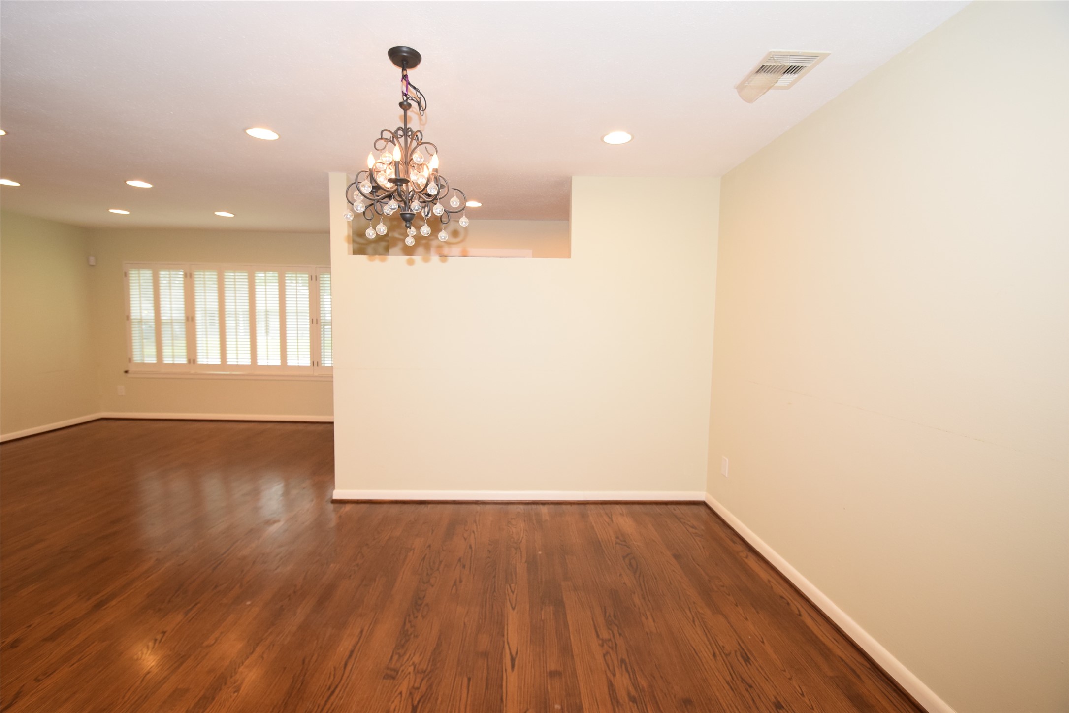 8434 Bluegate Street Houston, TX 77025 - Photo 8 of 28 wooden floor in an empty room with a window