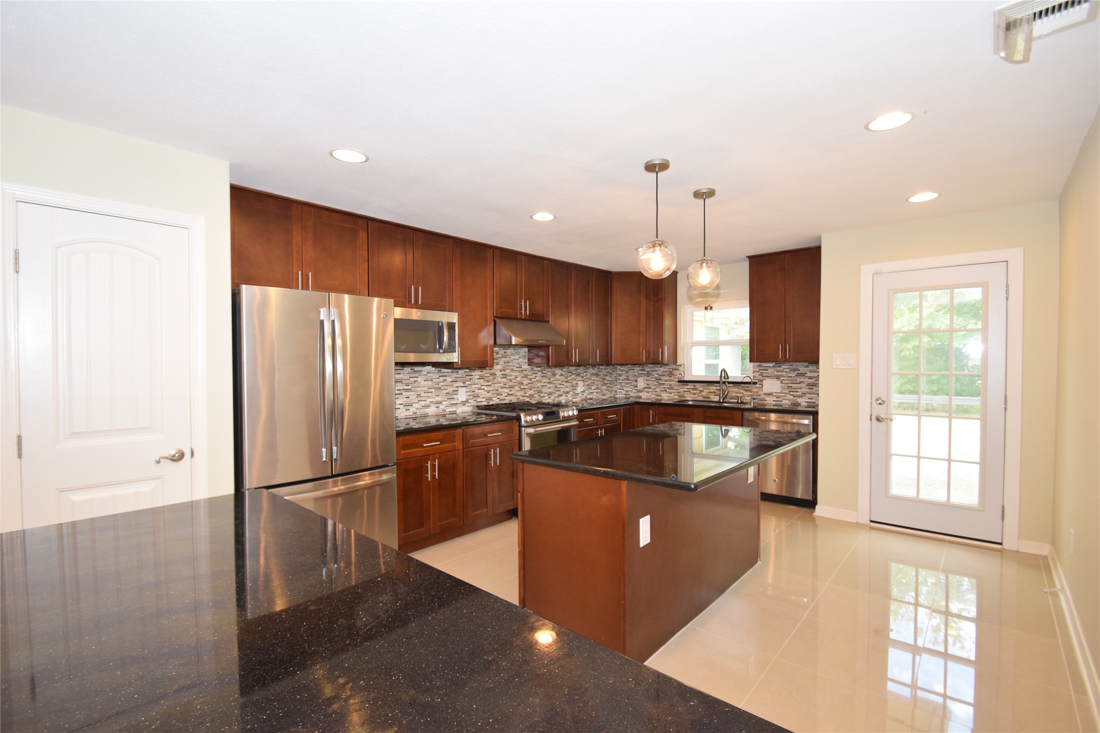 8434 Bluegate Street Houston, TX 77025 - Photo 9 of 28 a kitchen with stainless steel appliances granite countertop a refrigerator a sink dishwasher a stove and a refrigerator