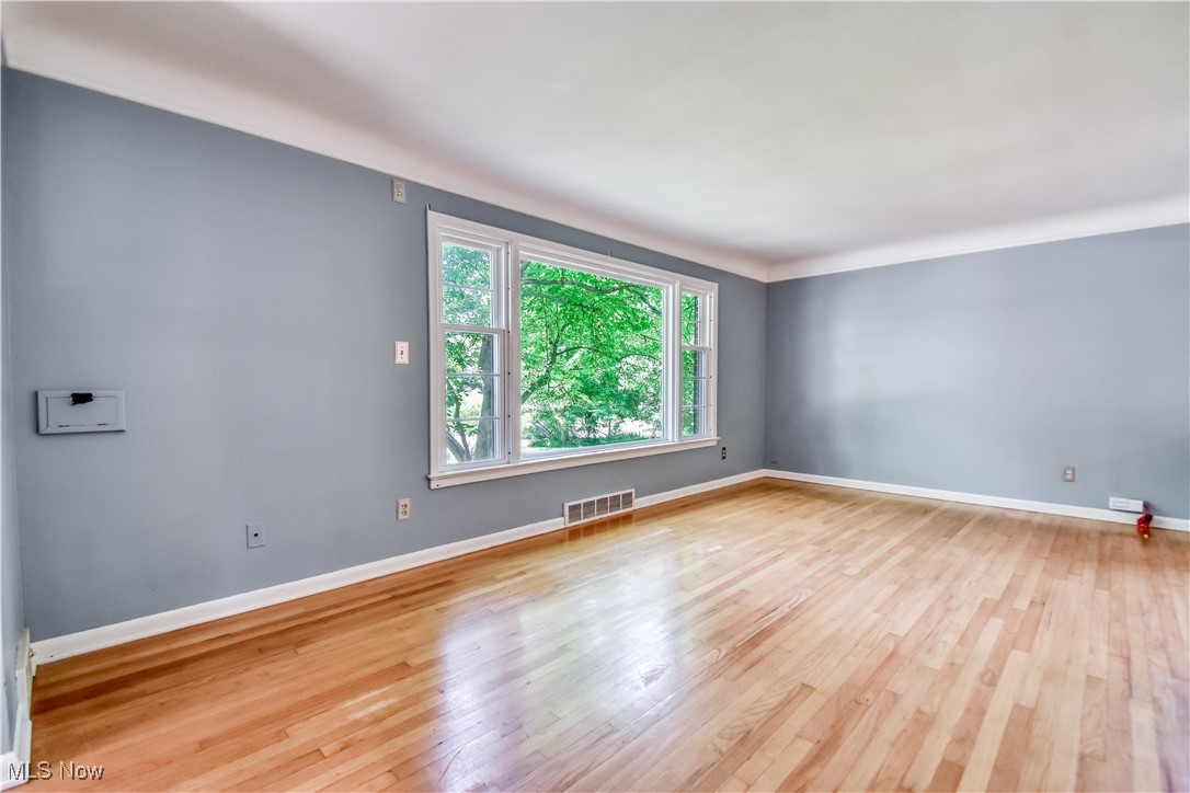 2607 Ashurst Road University Heights, OH 44118 - Photo 11 of 39 Empty room featuring wood finished floors and baseboards