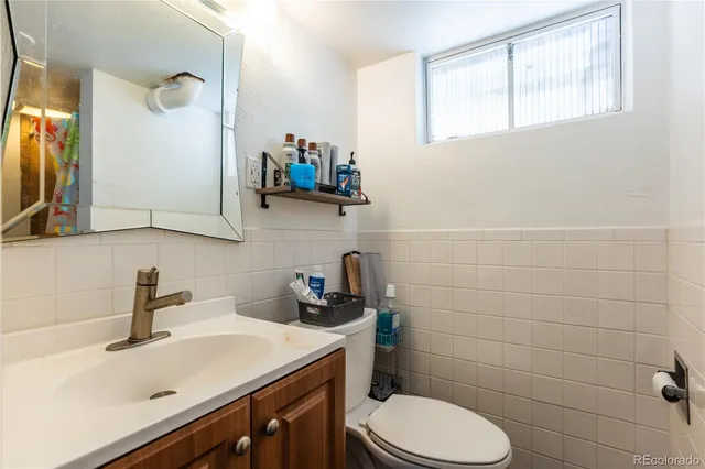a bathroom with a sink a toilet and mirror