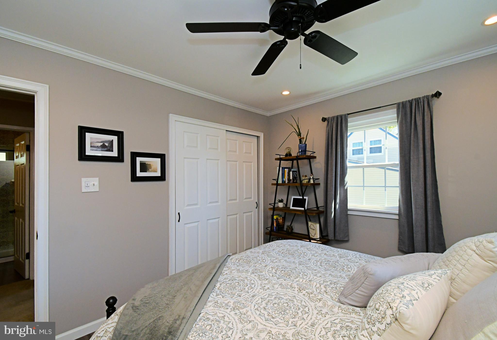20 Conifer Road Levittown, PA 19057 - Photo 21 of 52 a bedroom with a bed and a chandelier