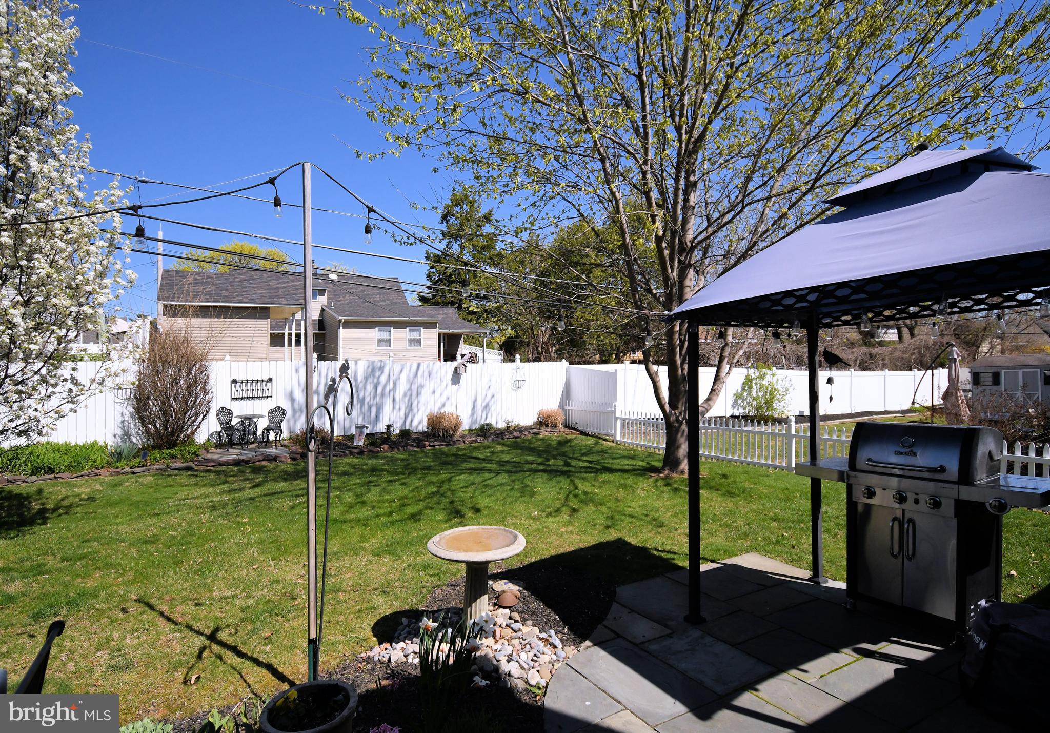 20 Conifer Road Levittown, PA 19057 - Photo 39 of 52 a view of a patio with a table chairs and a backyard