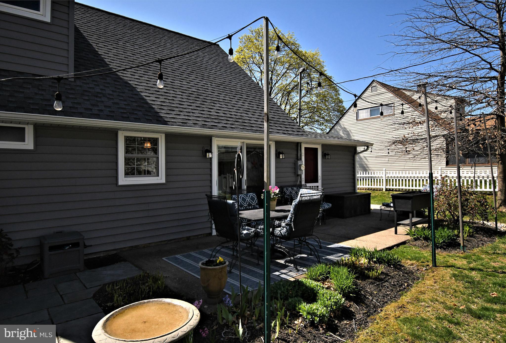 20 Conifer Road Levittown, PA 19057 - Photo 48 of 52 a view of a patio with table and chairs potted plants and floor to ceiling window
