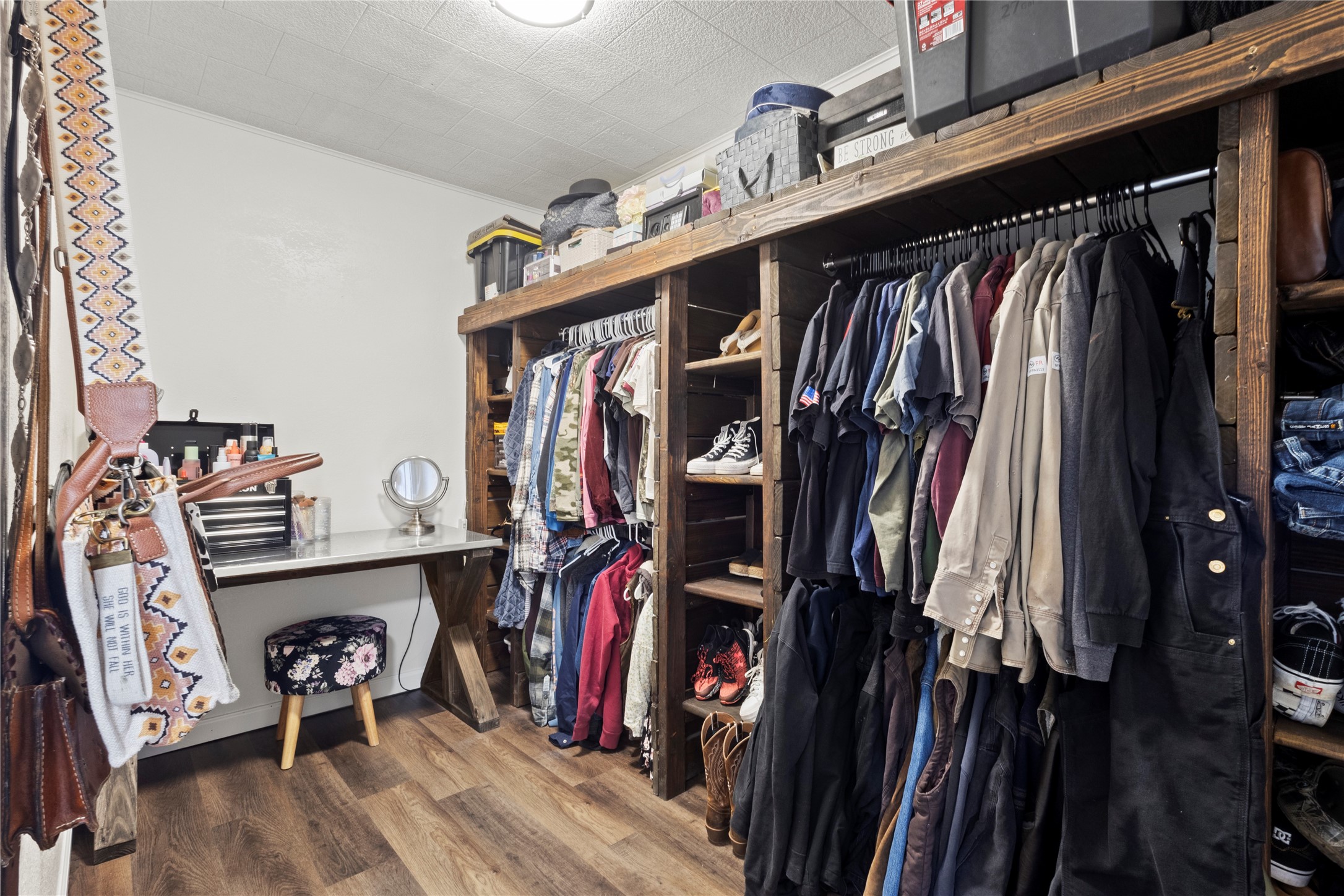 19961 Englin Road Winnie, TX 77665 - Photo 22 of 26 a view of walk in closet with clothes and shoes
