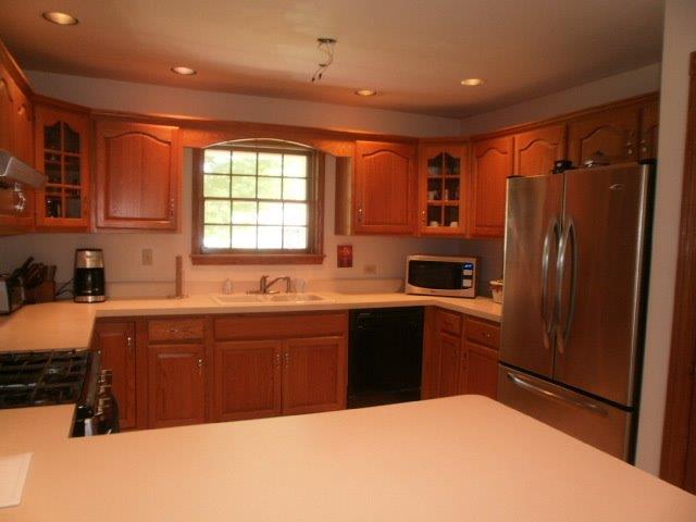 2590 East 1069th Road Oglesby, IL 61348 - Photo 8 of 15 a kitchen with stainless steel appliances granite countertop a refrigerator and sink