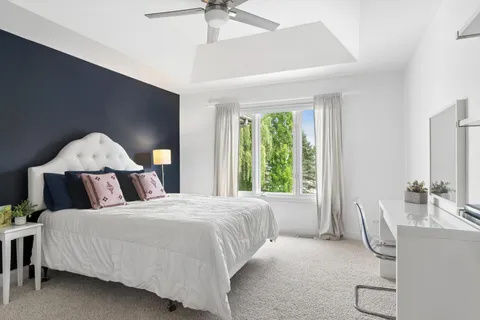 a bed room with a bed and a chair