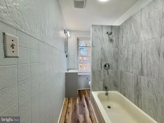 a bathroom with a bathtub and shower