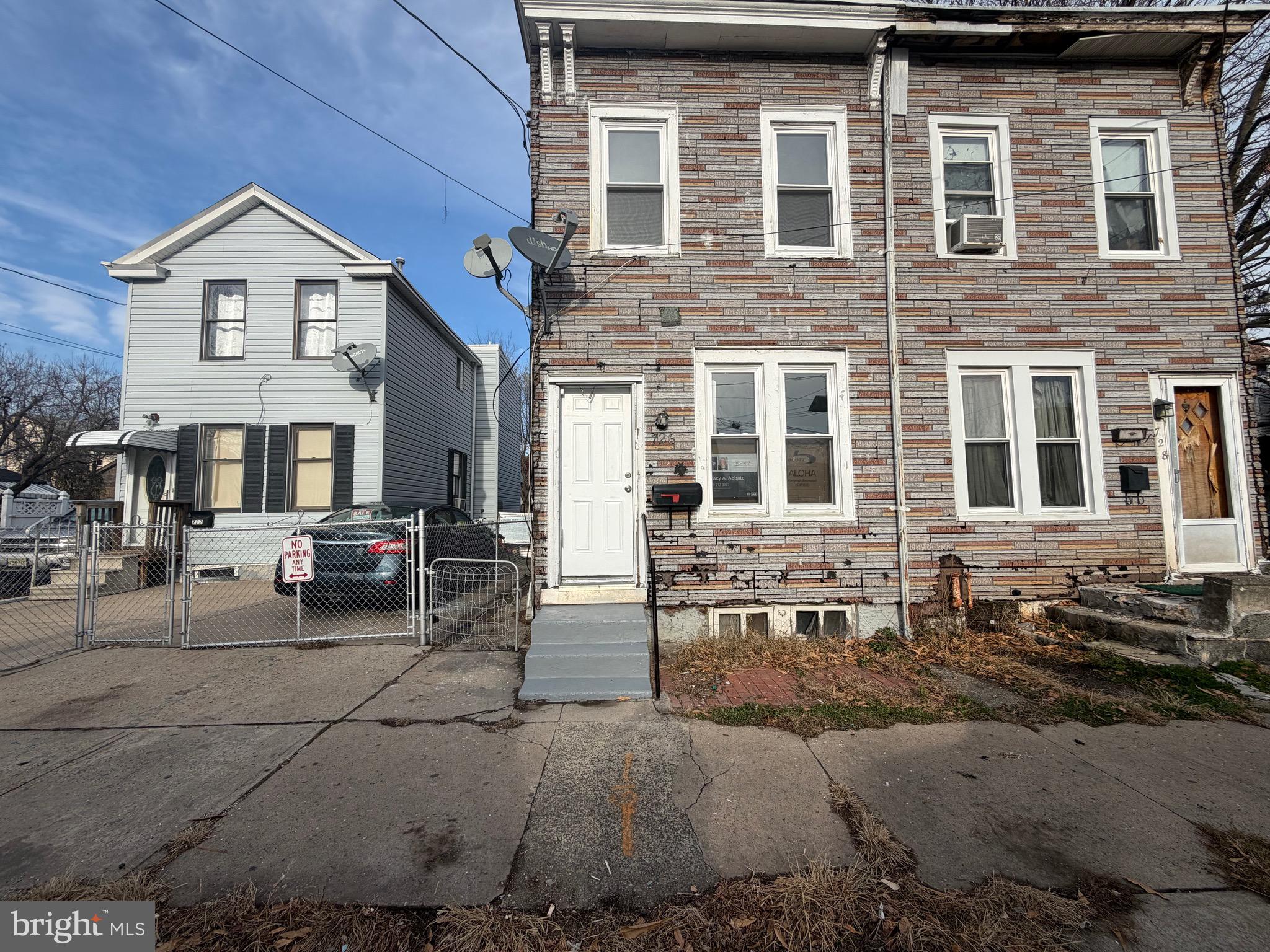 726 Genesee Street Trenton, NJ 08611 - Photo 2 of 15 a view of a brick house with many windows and chairs