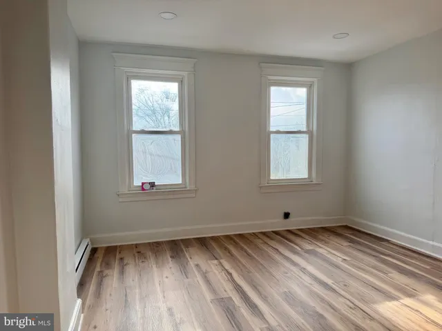 a view of room with window and hardwood floor