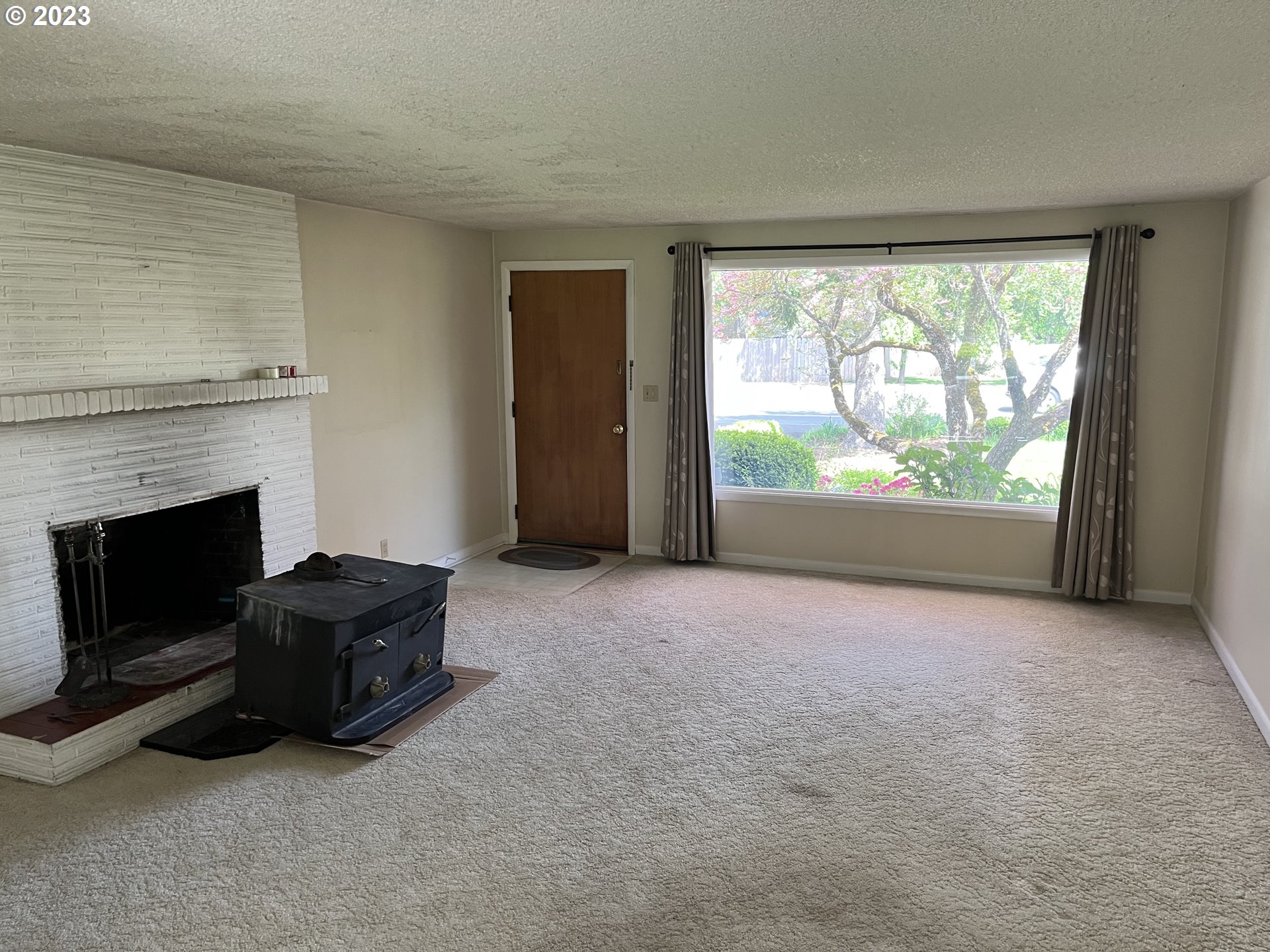 1526 Green Acres Road Eugene, OR 97408 - Photo 3 of 10 a living room with furniture and a fireplace