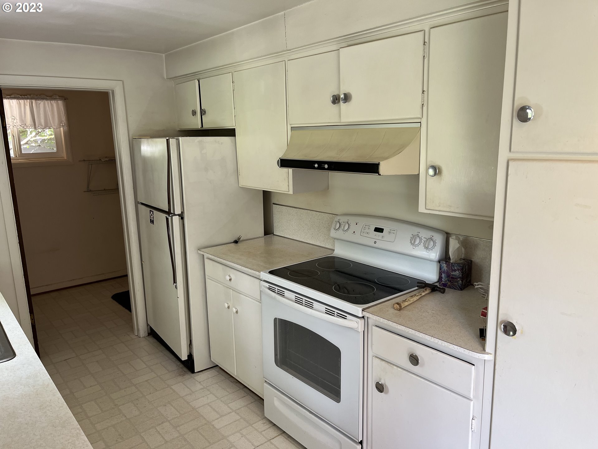 1526 Green Acres Road Eugene, OR 97408 - Photo 4 of 10 a kitchen with white cabinets and white appliances