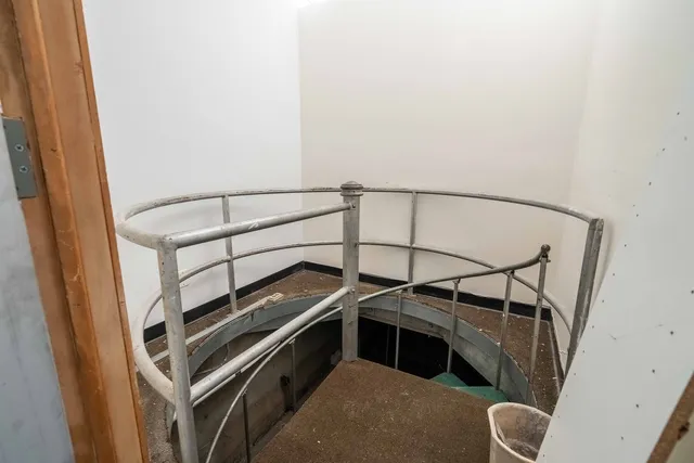 a view of empty room with wooden walls