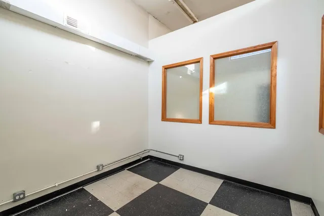 a kitchen with a checkered floor and a stove top oven