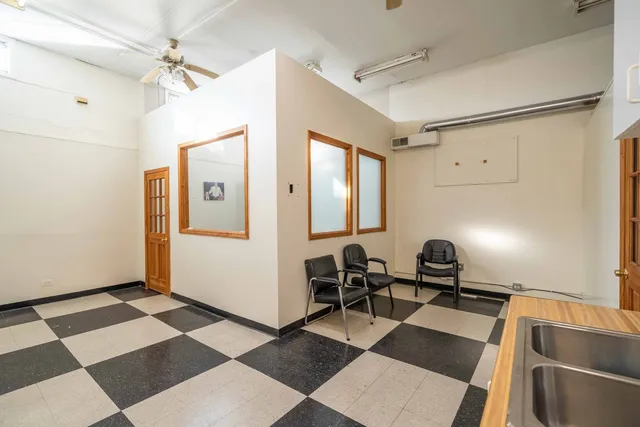 a view of a hallway with furniture and a window