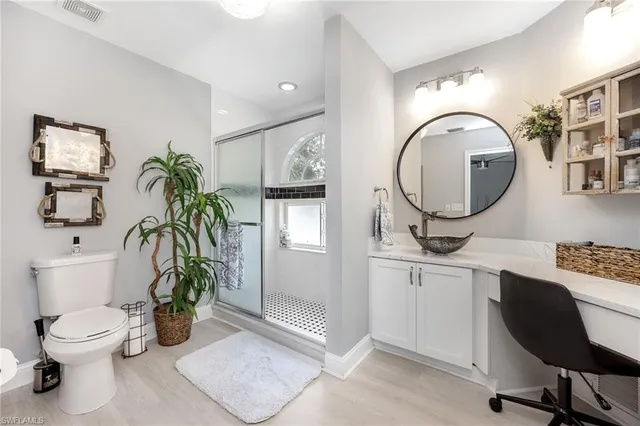 a bathroom with a toilet a sink and mirror