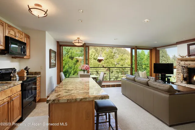 a living room with fireplace furniture and a flat screen tv