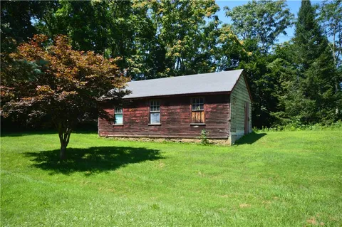 a view of a house with a backyard