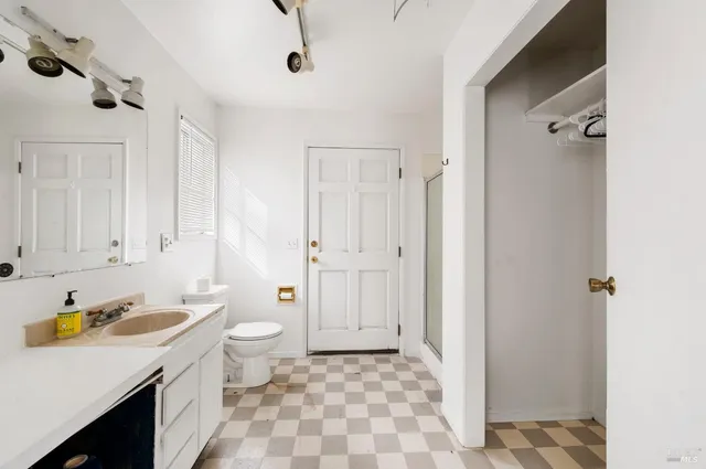a view of a bedroom with window and hardwood floor