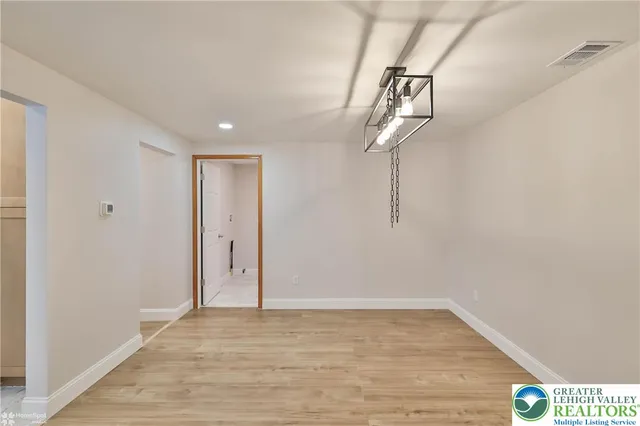 a kitchen with a sink stove top oven and refrigerator