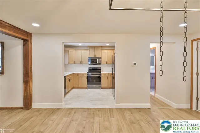 a kitchen with stainless steel appliances granite countertop a refrigerator and a sink