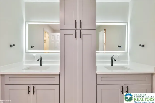 a white toilet sitting next to a white sink