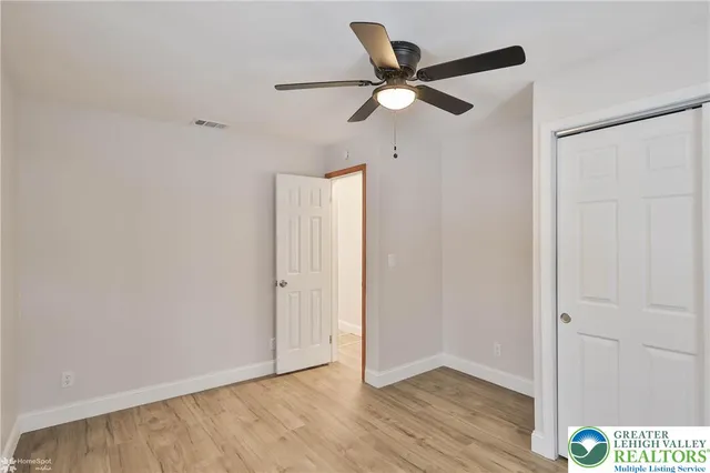 a front view of a house with a fence