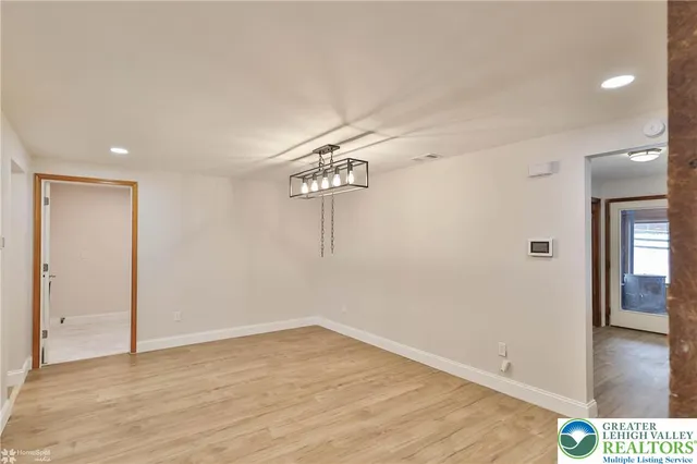 a view of a room with wooden floor