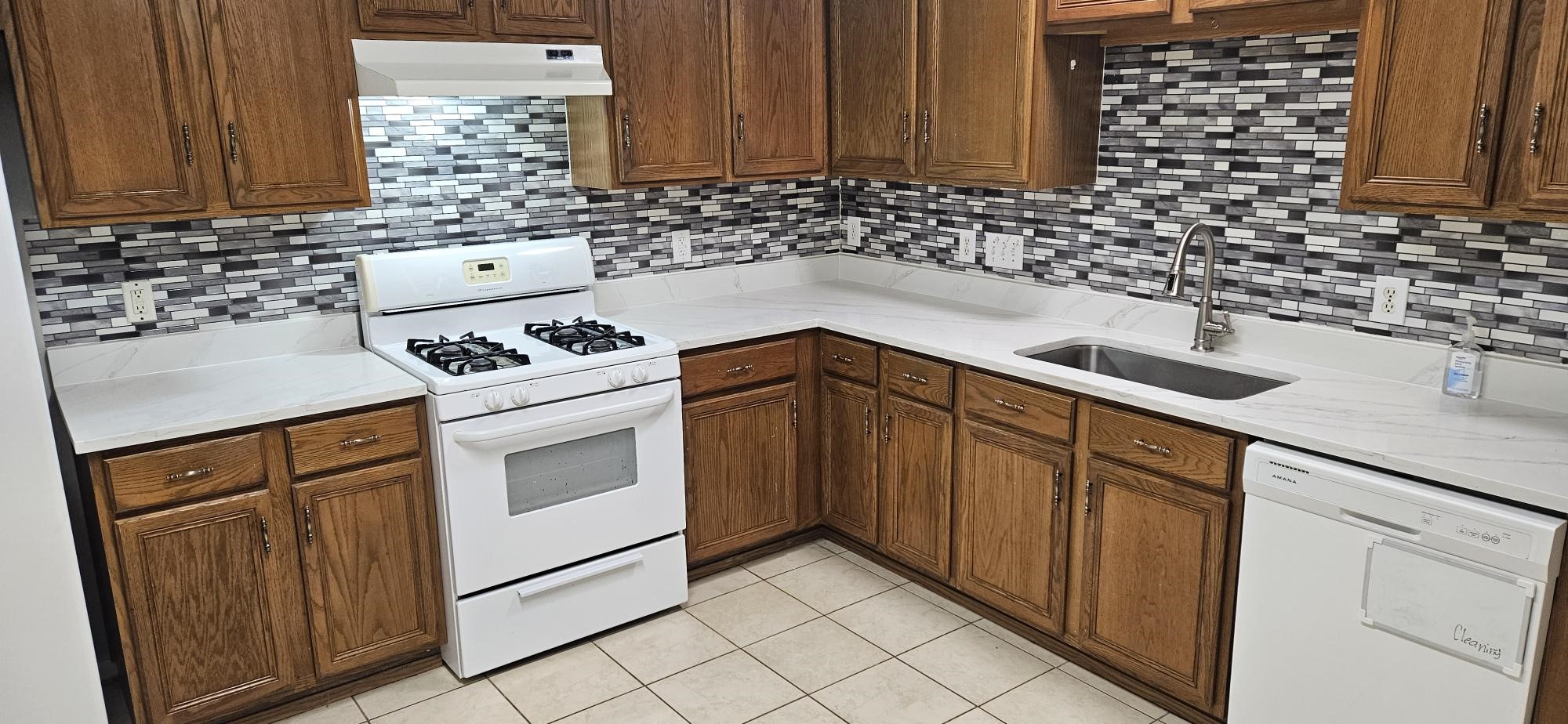 8331 Swiftwater Lane Houston, TX 77075 - Photo 5 of 14 a kitchen with granite countertop white cabinets and white appliances
