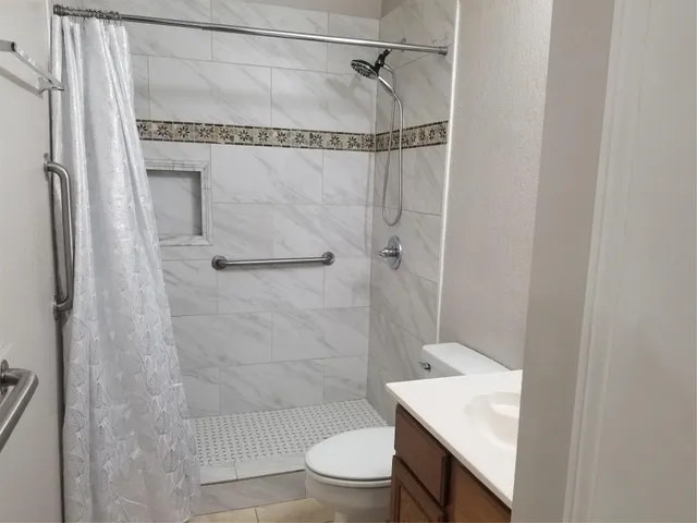 a bathroom with a sink toilet and shower