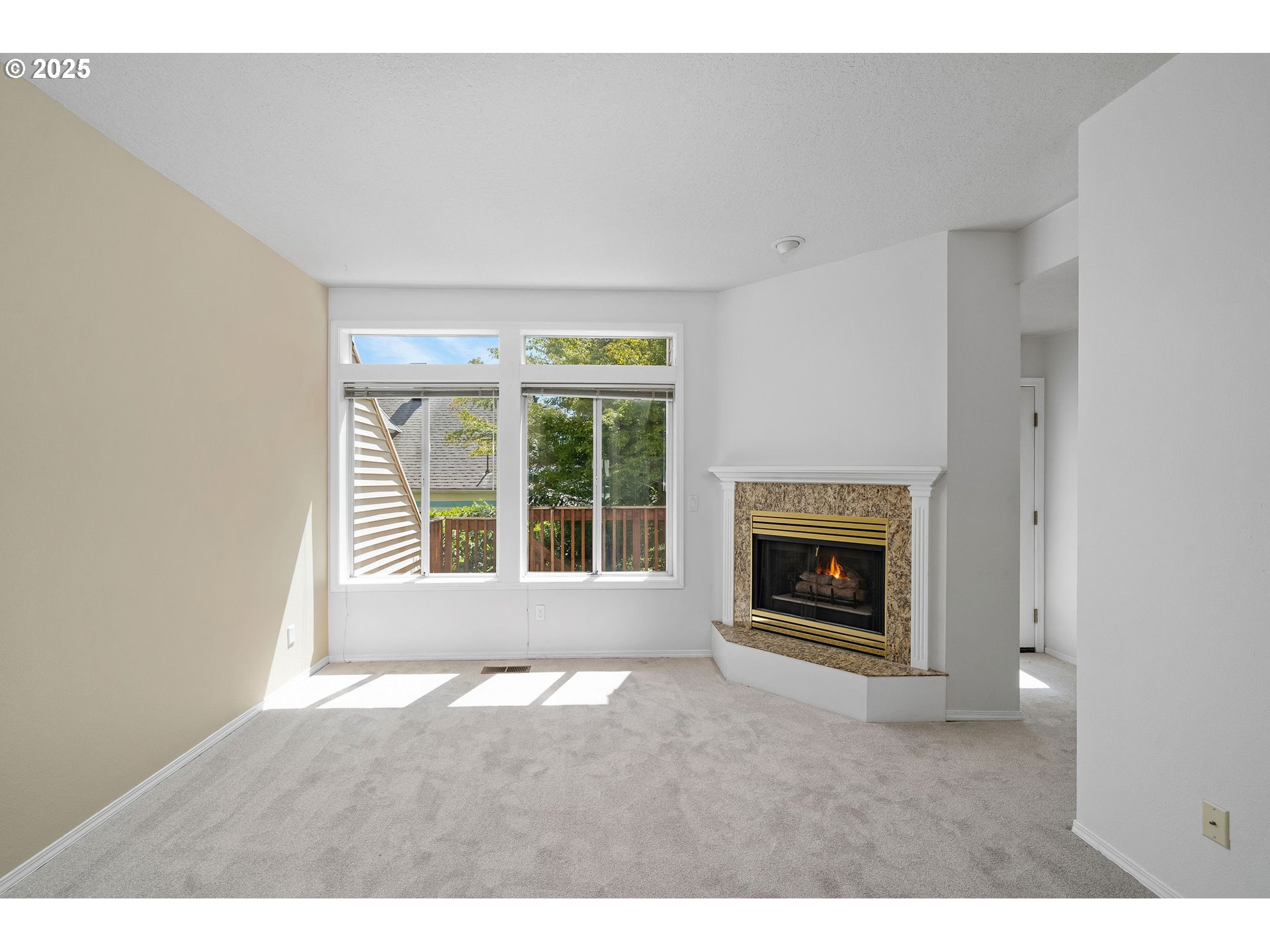 236 South Sweeney Street Portland, OR 97239 - Photo 12 of 29 a view of an empty room with a fireplace and a window