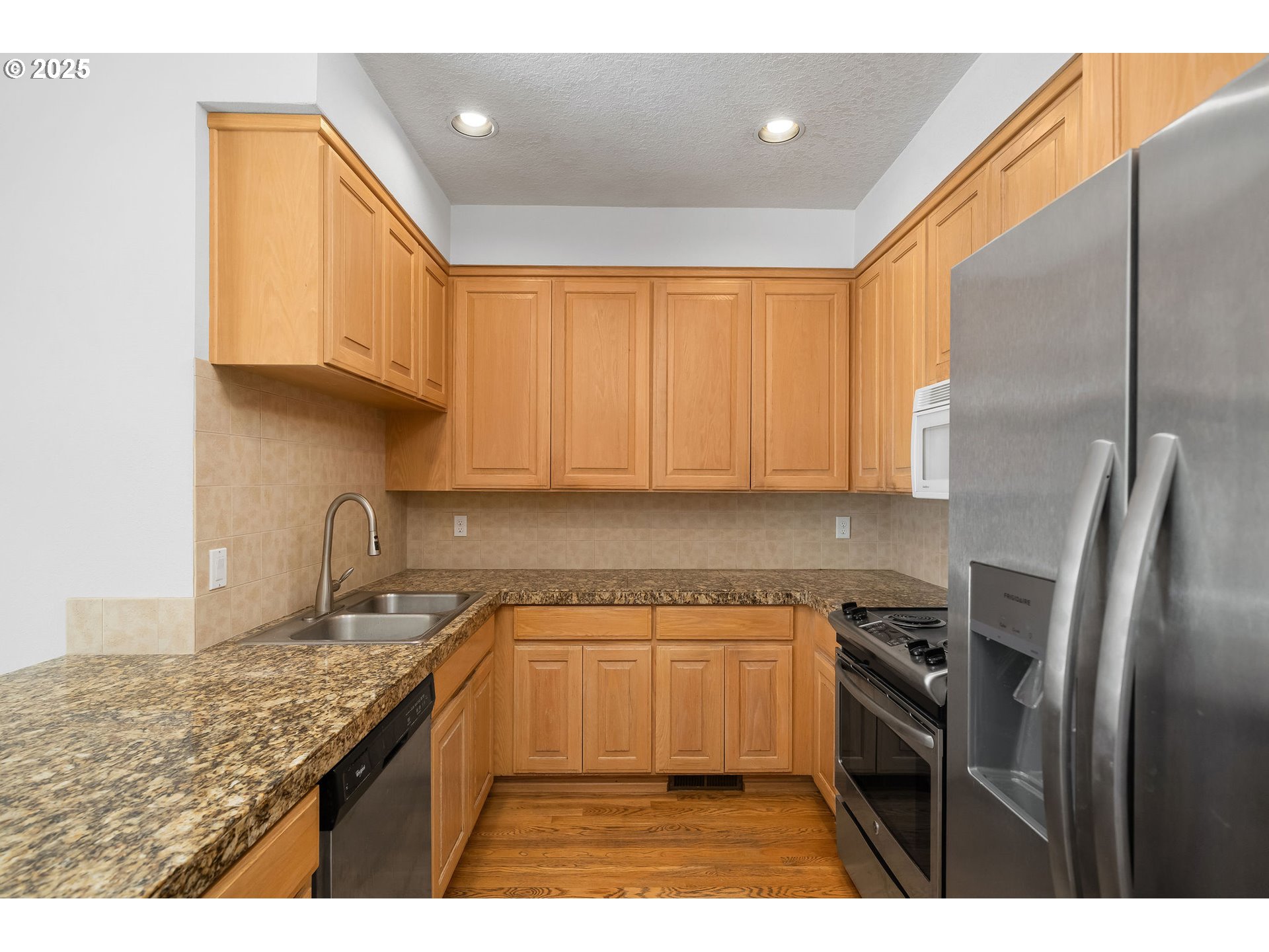 236 South Sweeney Street Portland, OR 97239 - Photo 8 of 29 a kitchen with granite countertop a sink stainless steel appliances and cabinets