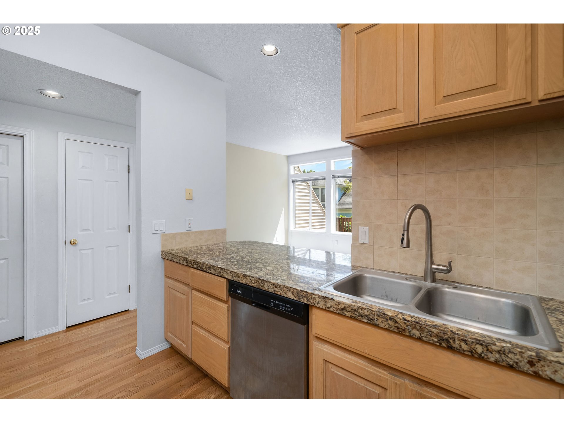 236 South Sweeney Street Portland, OR 97239 - Photo 10 of 29 a kitchen with granite countertop a sink and a wooden cabinets