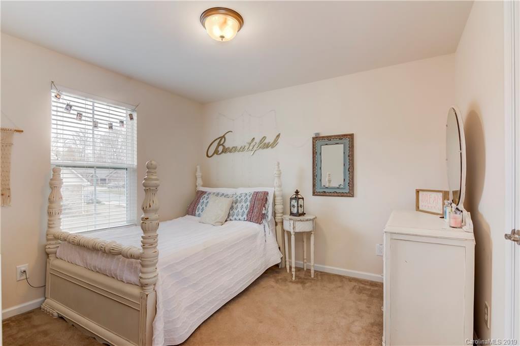 7512 West Berkeley Road Denver, NC 28037 - Photo 17 of 32 a bedroom with a bed and a window