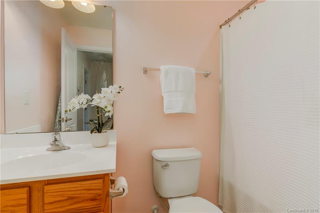 7512 West Berkeley Road Denver, NC 28037 - Photo 18 of 32 a bathroom with a sink toilet and mirror