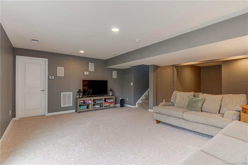 7512 West Berkeley Road Denver, NC 28037 - Photo 25 of 32 a living room with furniture and a flat screen tv