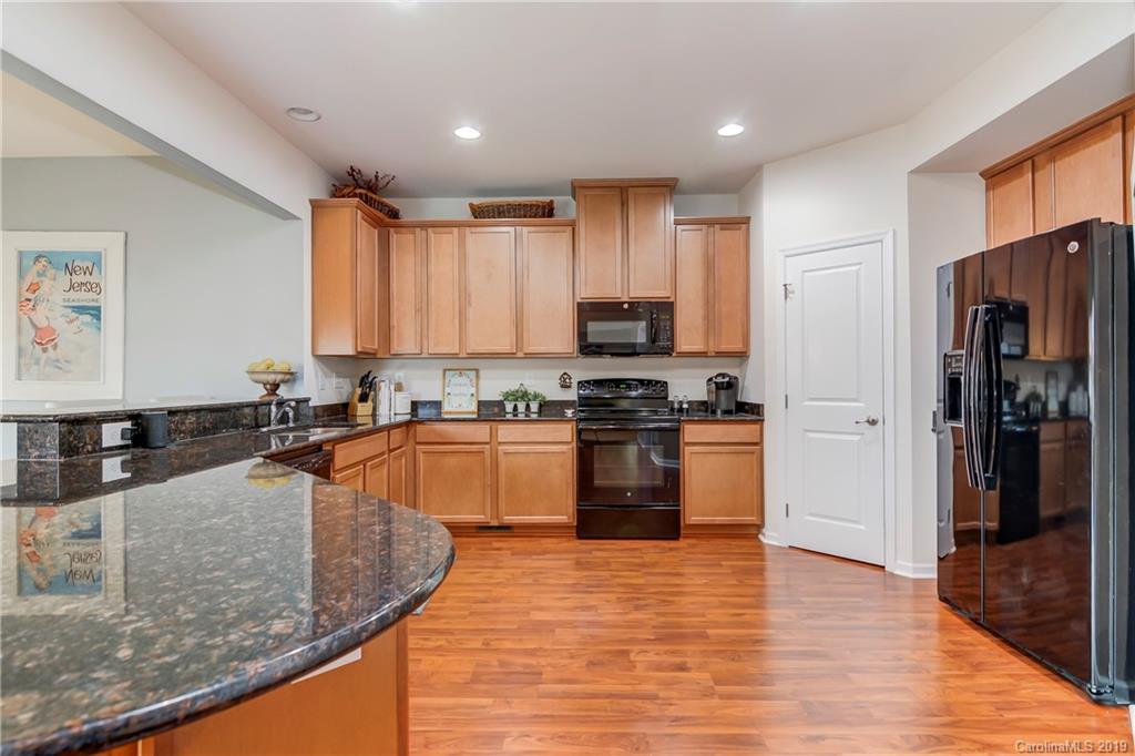 7512 West Berkeley Road Denver, NC 28037 - Photo 10 of 32 a kitchen with stainless steel appliances granite countertop a refrigerator a sink dishwasher a stove and white countertops with wooden floor