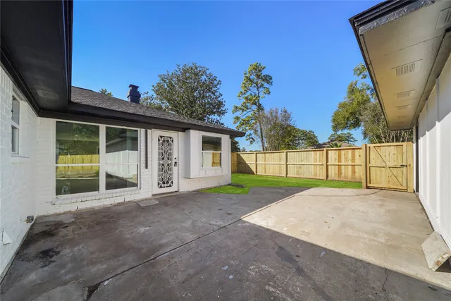 a view of backyard of house with green space