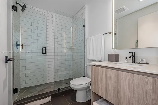 a bathroom with a toilet a sink and shower