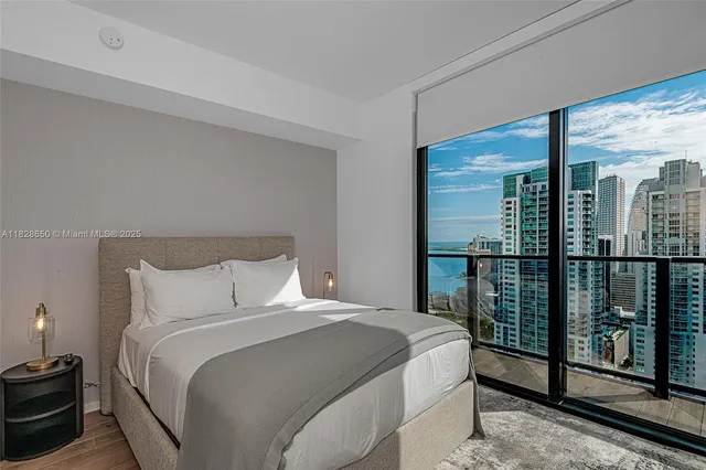 a bedroom with a large bed and a balcony view