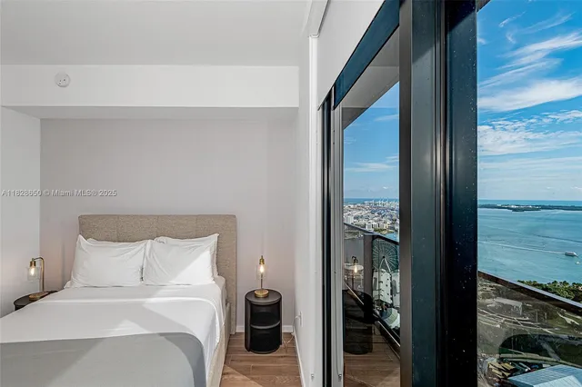 a bedroom with a bed and a view of balcony