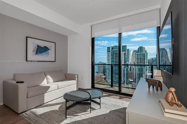 a living room with furniture and a large window