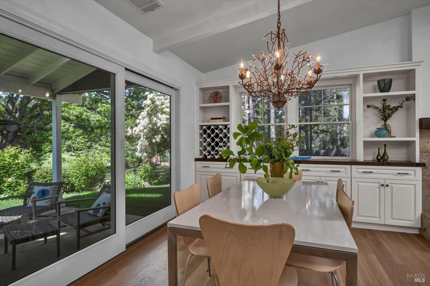 1065 Summit Lake Drive Angwin, CA 94508 - Photo 11 of 47 a dining room with furniture a potted plant and a chandelier